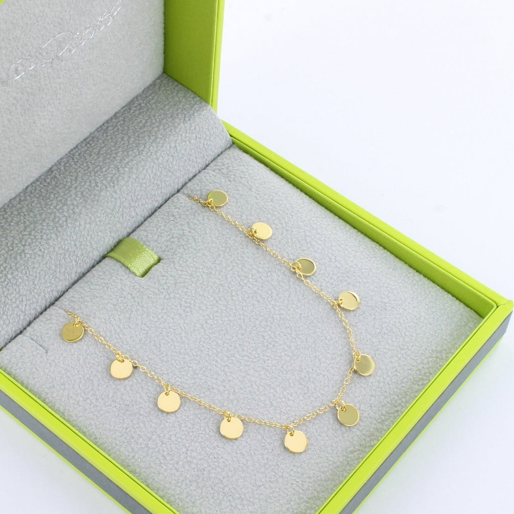 A fine Sterling Silver and gold plate chain, with high shine disc charms spread evenly along the chain. Shown in a Reeves & Reeves grey and green branded gift box.