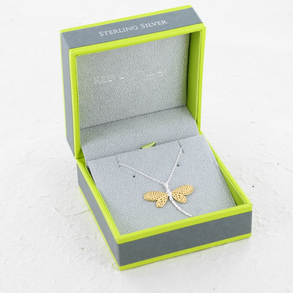 gold and silver dragonfly pendant on a chain being shown in a Reeves & Reeves branded gift box, in the brand colours green and grey.