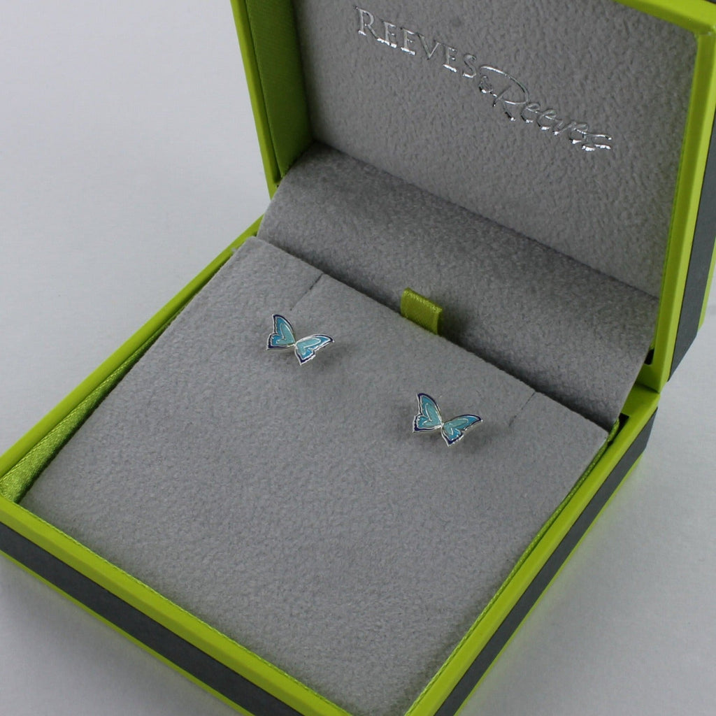 A pair of sterling silver Butterfly stud earrings with blue enamel detail, shown in a Reeves & Reeves gift box.