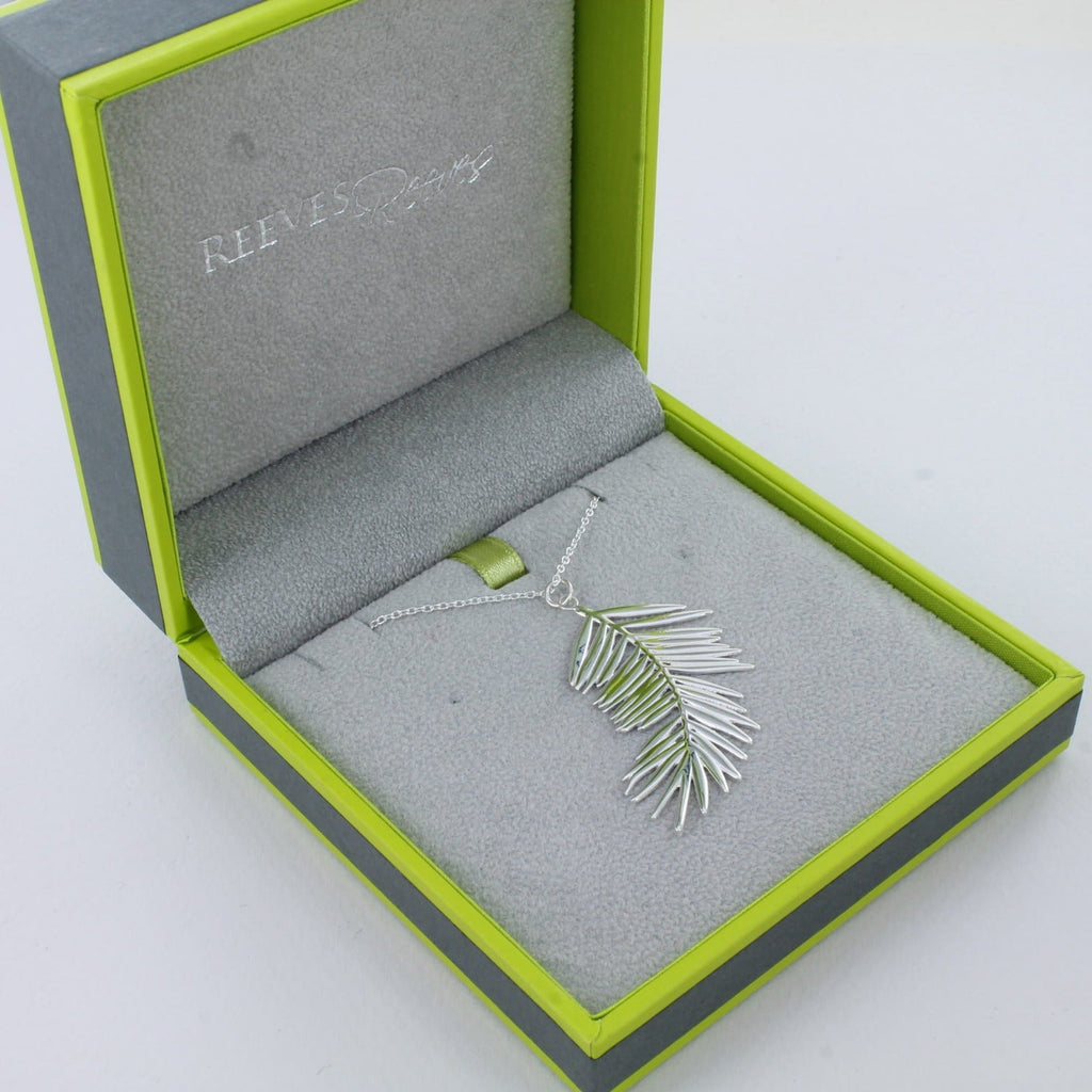 Sterling Silver Fern Leaf Pendant, on a silver adjustable chain and shown in a Reeves & Reeves grey and green branded box.