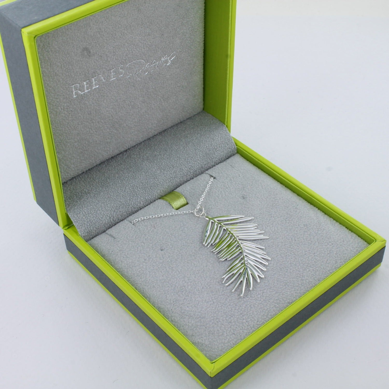 Sterling Silver Fern Leaf Pendant, on a silver adjustable chain and shown in a Reeves & Reeves grey and green branded box.