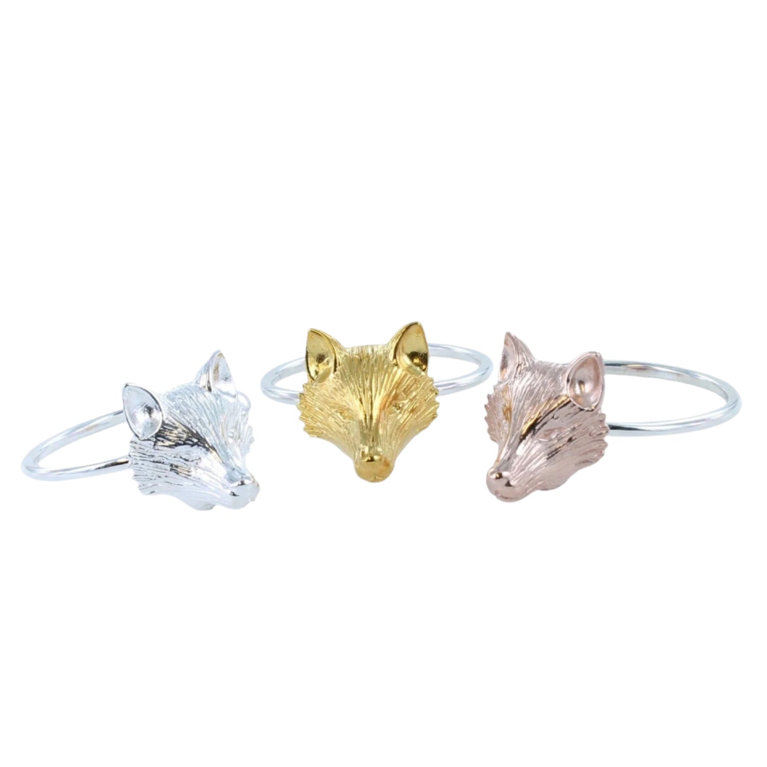Three silver adjustable banded rings with fox heads as the central feature in silver, gold, and rose gold.