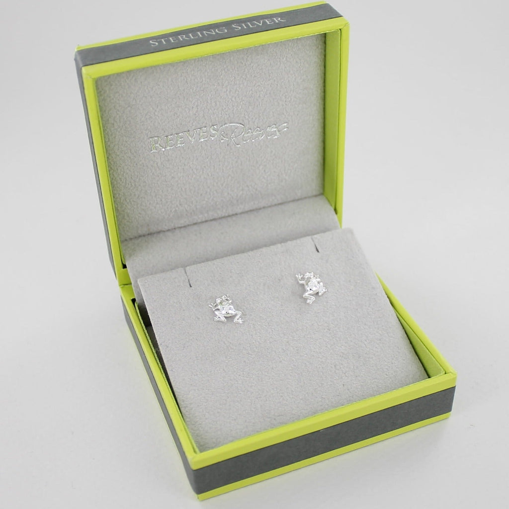 A pair of sterling silver Frog Stud Earrings, shown in a Reeves & Reeves grey and green gift box.
