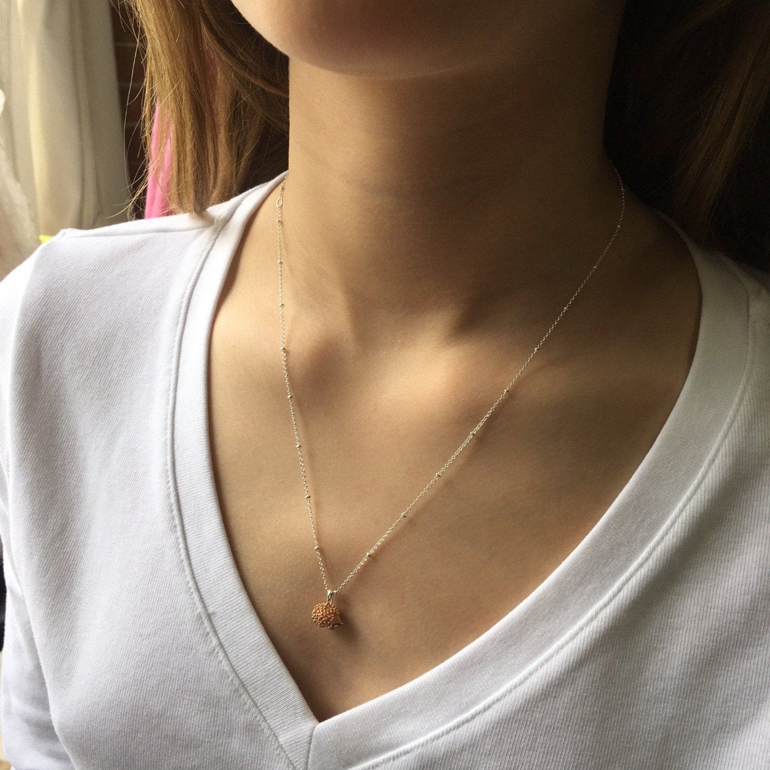 Hedgehog Pendant on a silver adjustable chain worn on a model.