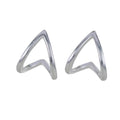 A pair of sterling silver huggie style earrings in a heart shape with a high shine finish.