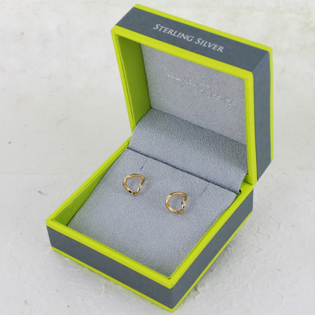 A pair of heart huggies in sterling silver with 18ct gold plating and shown in a Reeves & Reeves gift box.