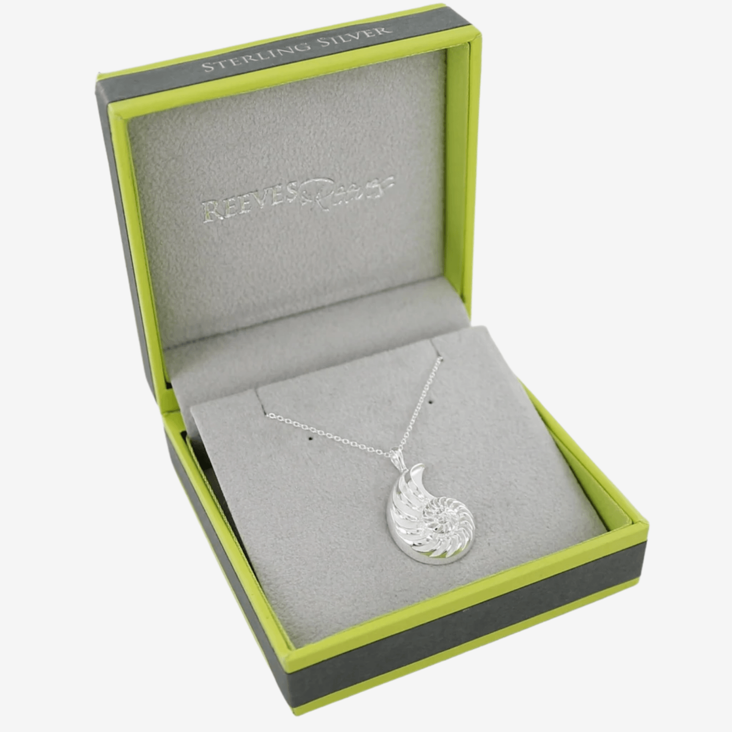 A large silver Ammonite Shell Necklace on a silver chain and shown in a Reeves & Reeves branded gift box.