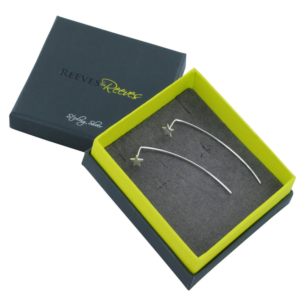 A pair of sterling silver star earrings with a long silver bar at the back, shown in a Reeves & Reeves gift box.