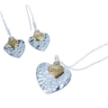Hammered heart pendant with a gold plated heart sat on top with 'love' enscribed and hung on a silver adjustable chain.