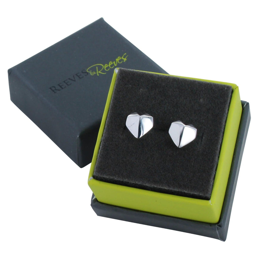 A pair of sterling silver heart stud earrings in an origami design and shown in a Reeves & Reeves gift box.