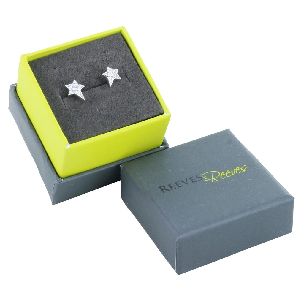 A pair of sterling silver star studs with cubic zirconia stones, shown in a Reeves & Reeves gift box.