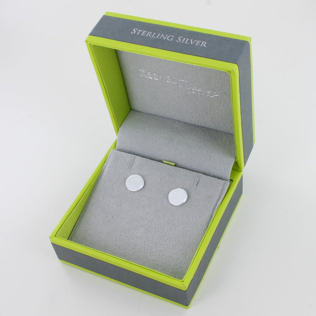 A pair of sterling silver disc stud earrings, shown in a Reeves & Reeves gift box.