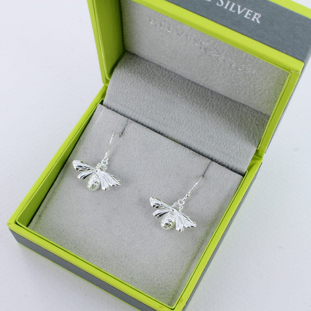 A pair of sterling silver Queen Bee Drop Earrings, hung on silver hooks and shown in a Reeves & Reeves gift box.