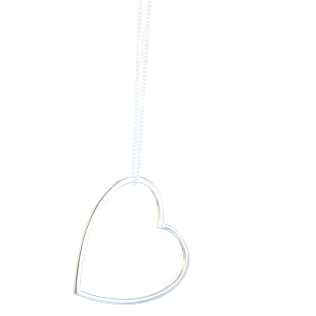 A sterling silver heart silhouette necklace with gold vermeil edges, hanging from an adjustable sterling silver chain.