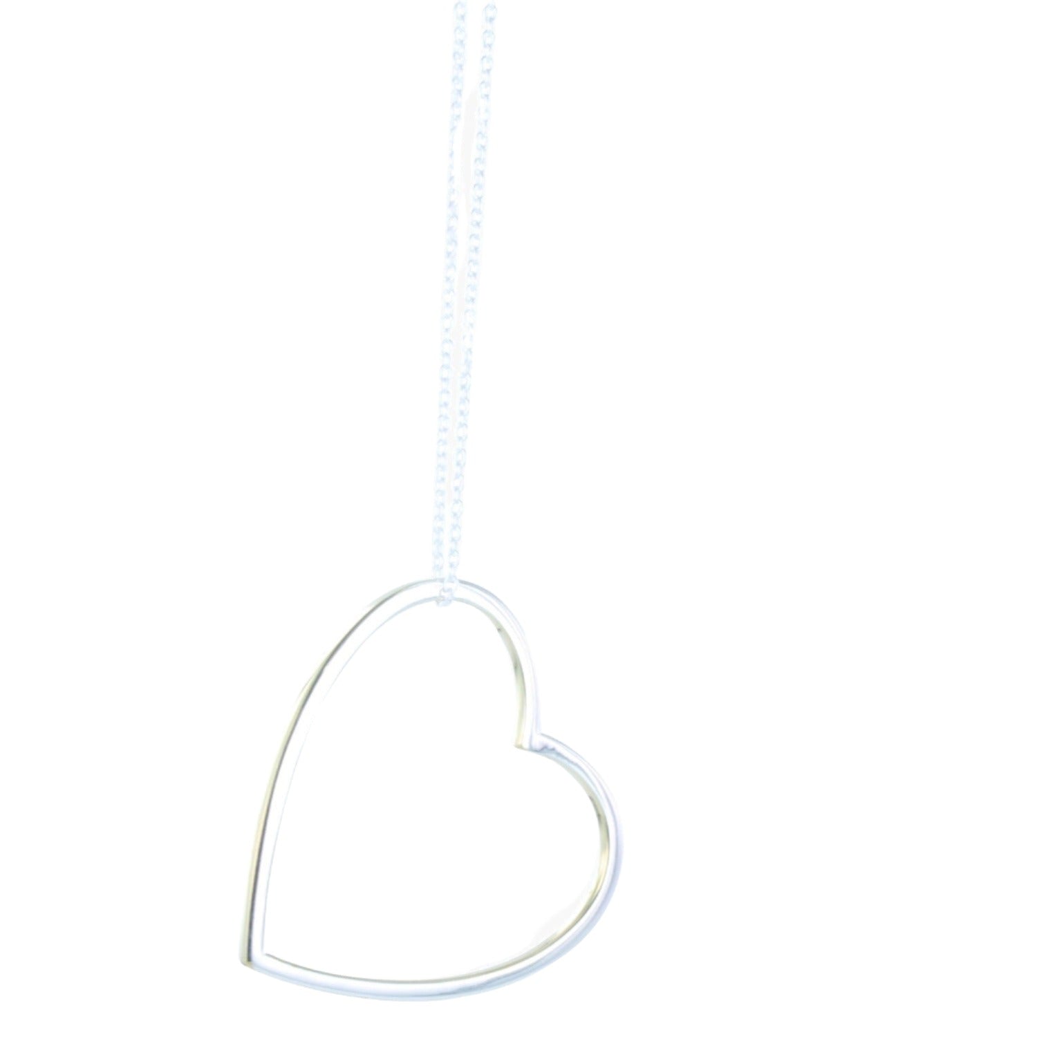A sterling silver heart silhouette necklace with gold vermeil edges, hanging from an adjustable sterling silver chain.