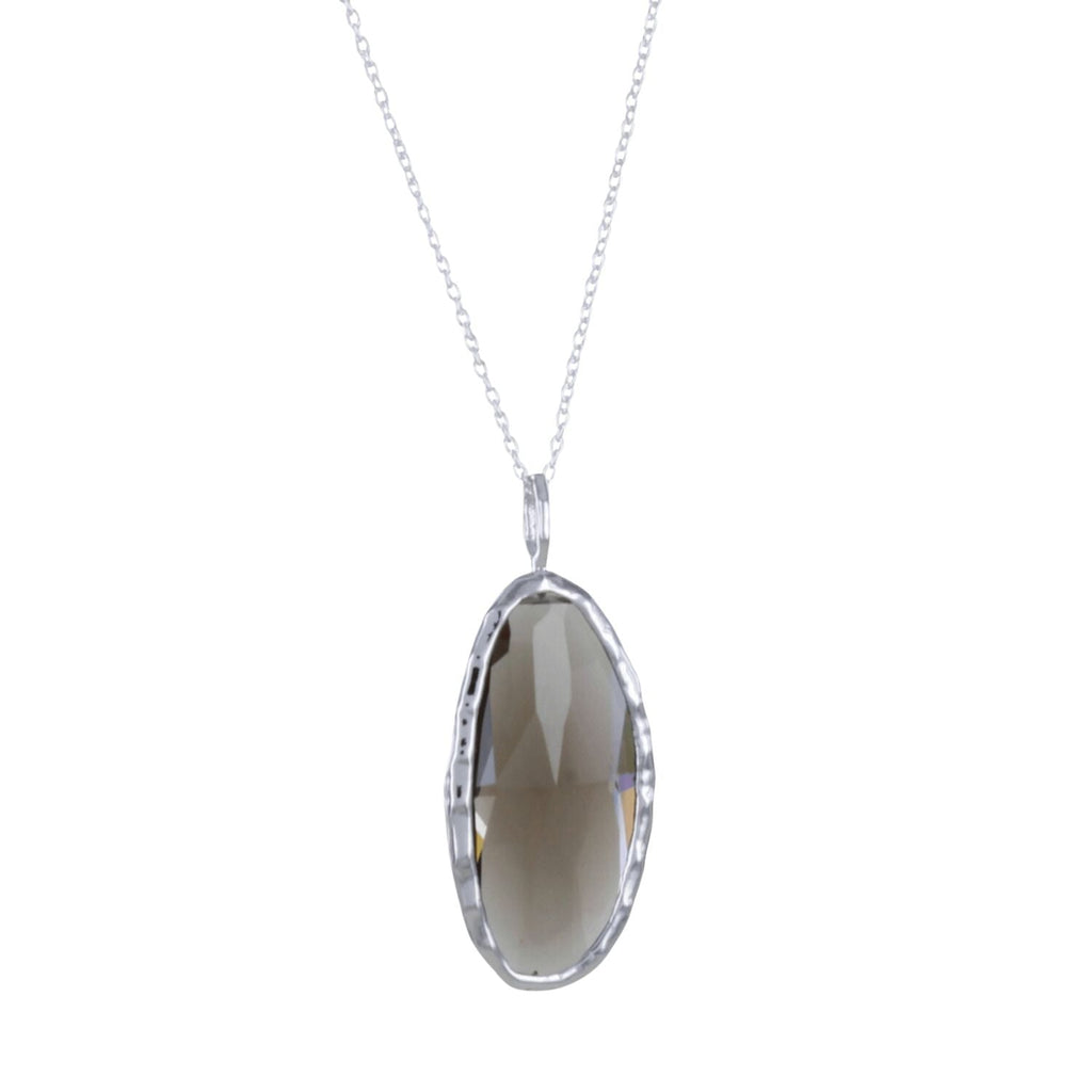 An oval smokey quartz semi precious stone, set in sterling silver and hung on a silver adjustable chain.