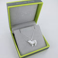 A Sterling Silver Highland Cow Necklace, on an adjustable silver chain, shown in a reeves and reeves branded gift box with grey and green colours.