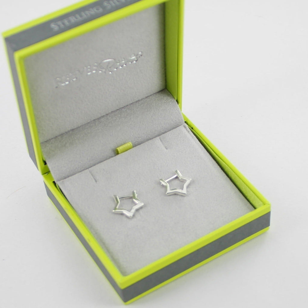 A pair of sterling silver star shaped huggie earrings, shown in a Reeves & Reeves gift box.