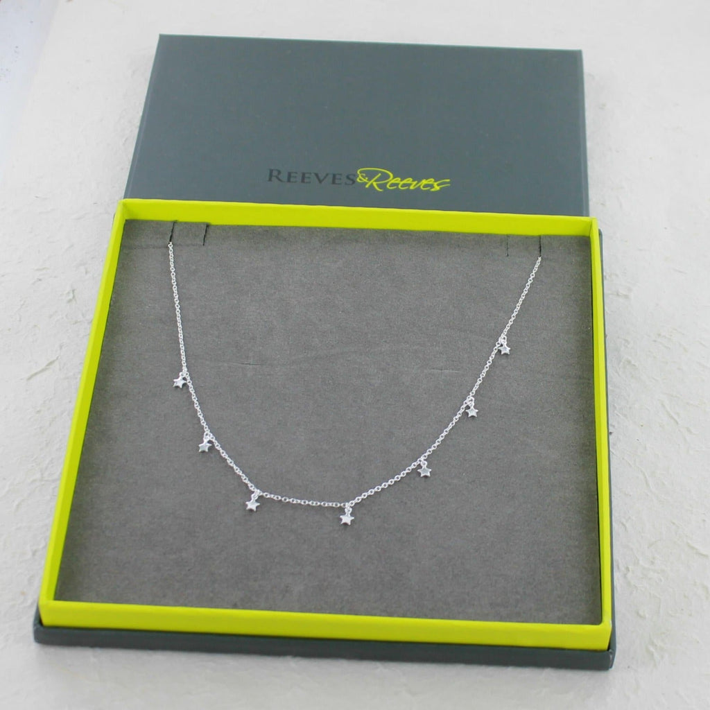 Sterling Silver Star Necklace in a Reeves & Reeves branded gift box with grey and green colours.