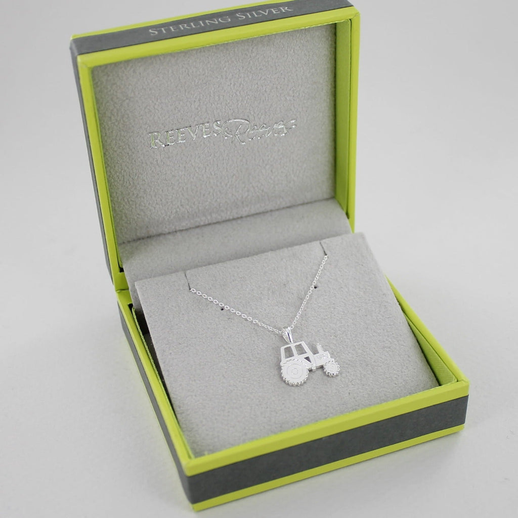 A sterling silver tractor necklace, on an adjustable silver chain and shown in a Reeves & Reeves gift box.
