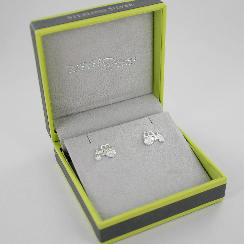 A pair of two dimensional, sterling silver tractor stud earrings, shown in a Reeves & Reeves gift box.