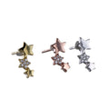 Three singular stud earrings, one sterling silver, one with 18ct yellow gold plating and one with 18ct rose gold plating. The stud has three stars of varying sizes adjoined in a vertical curved line, the middle star filled with cubic zirconia stones.