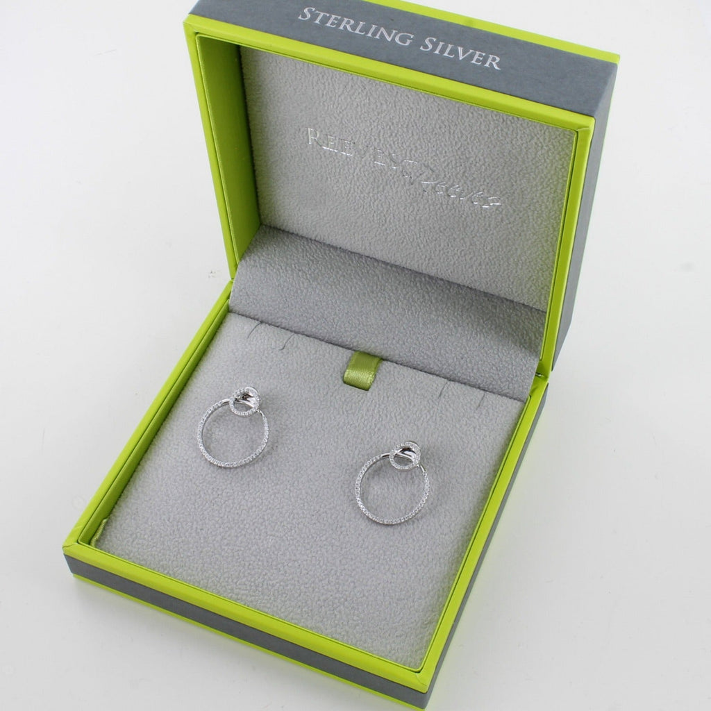 A pair of sterling silver circular earrings filled with cubic zirconia stones and shown in a Reeves & Reeves gift box.
