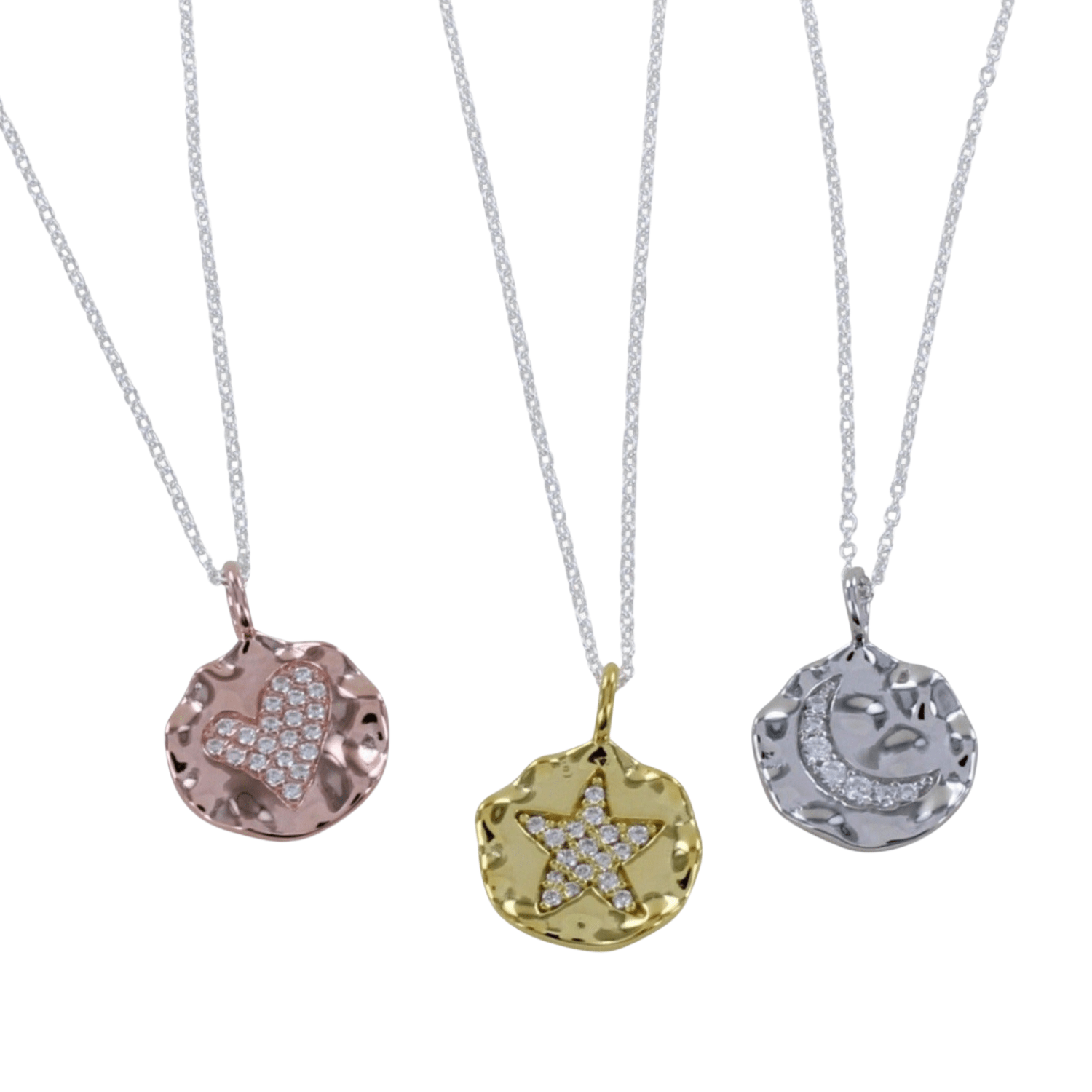 Three Textured Disc Necklaces in silver, gold vermeil, and rose gold colors, each with a different symbol in the center: a moon, star, and heart, encrusted with pavé CZ stones.
