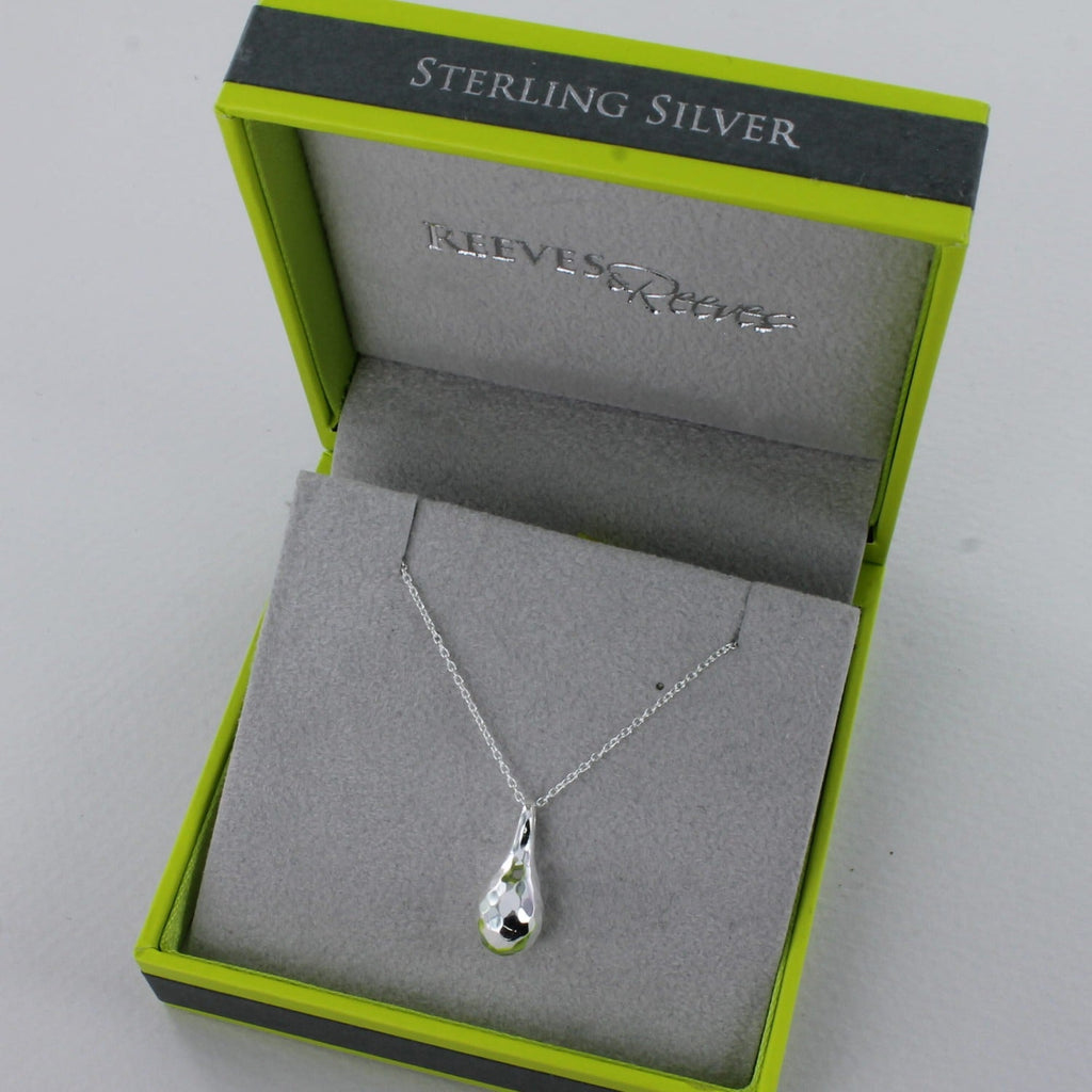 A Sterling Silver hammered teardrop pendant, hung on a silver chain and shown in a Reeves & Reeves branded gift box.