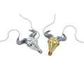 Two sterling silver necklaces, one with 18ct gold plate finish, featuring wildebeest skull designs with black ruthenium horns, suspended on adjustable silver chains.