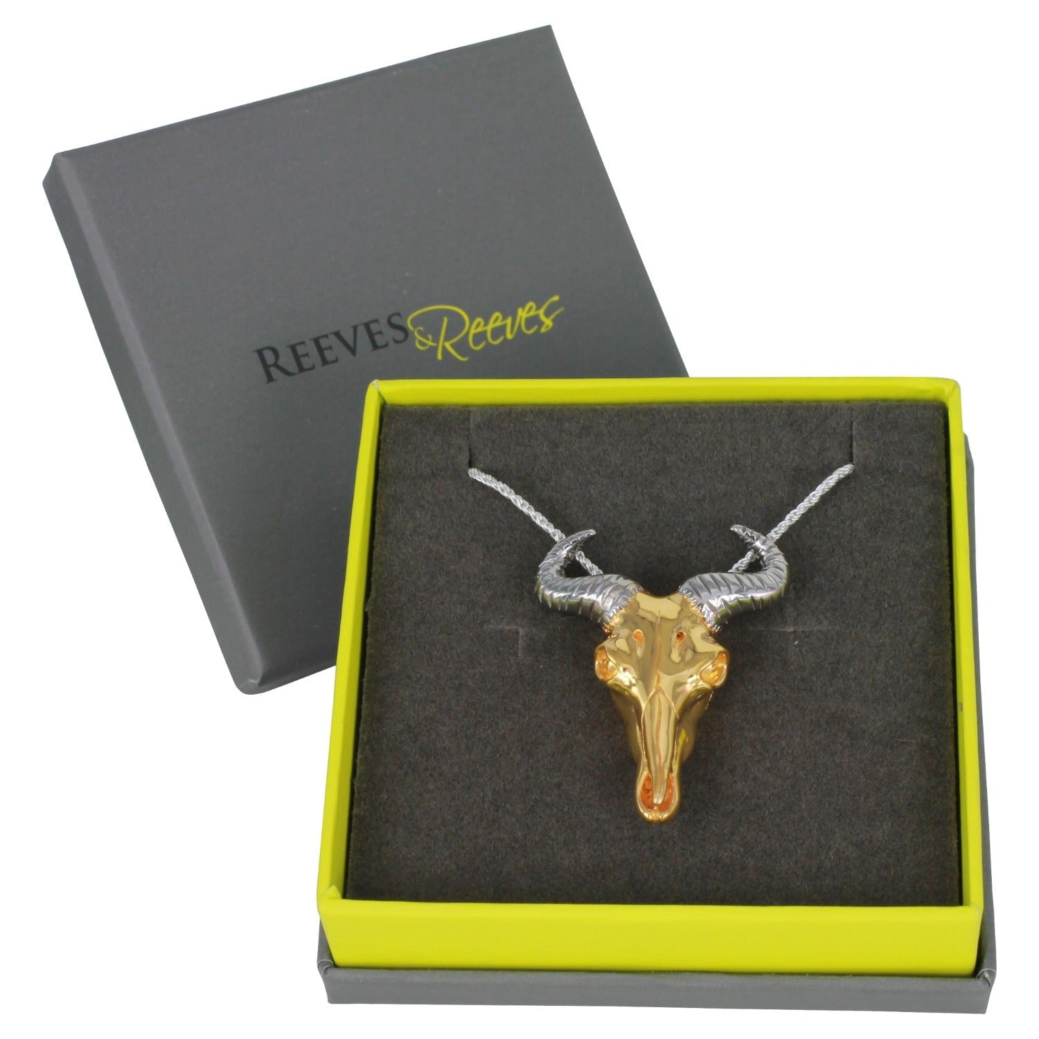 Gold plated wildebeest skull necklace, with black ruthenium horns on a rope style chain. Shown in a Reeves & Reeves grey and green branded box.